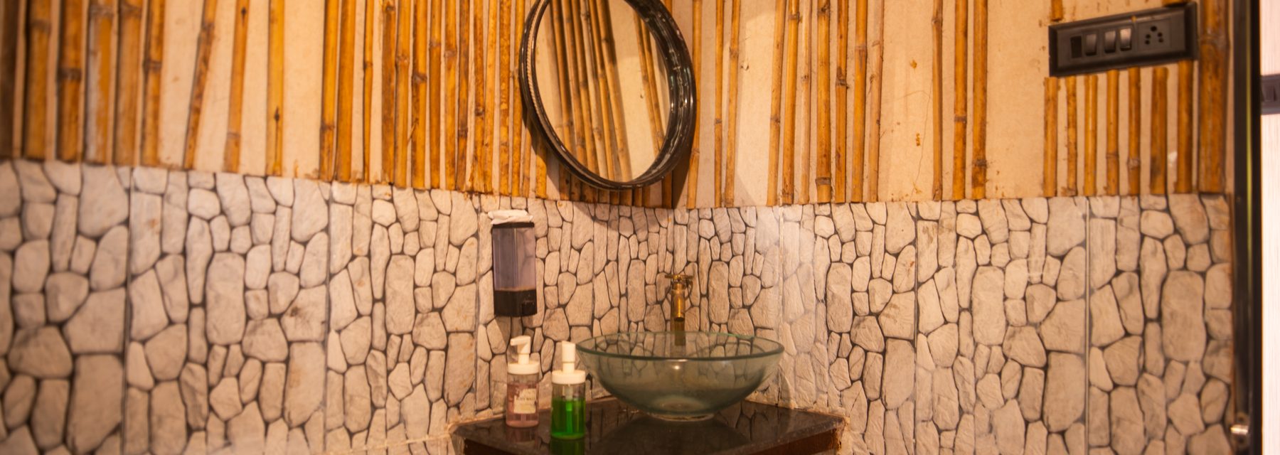 the container bathroom, bamboo and stone with a stone basin