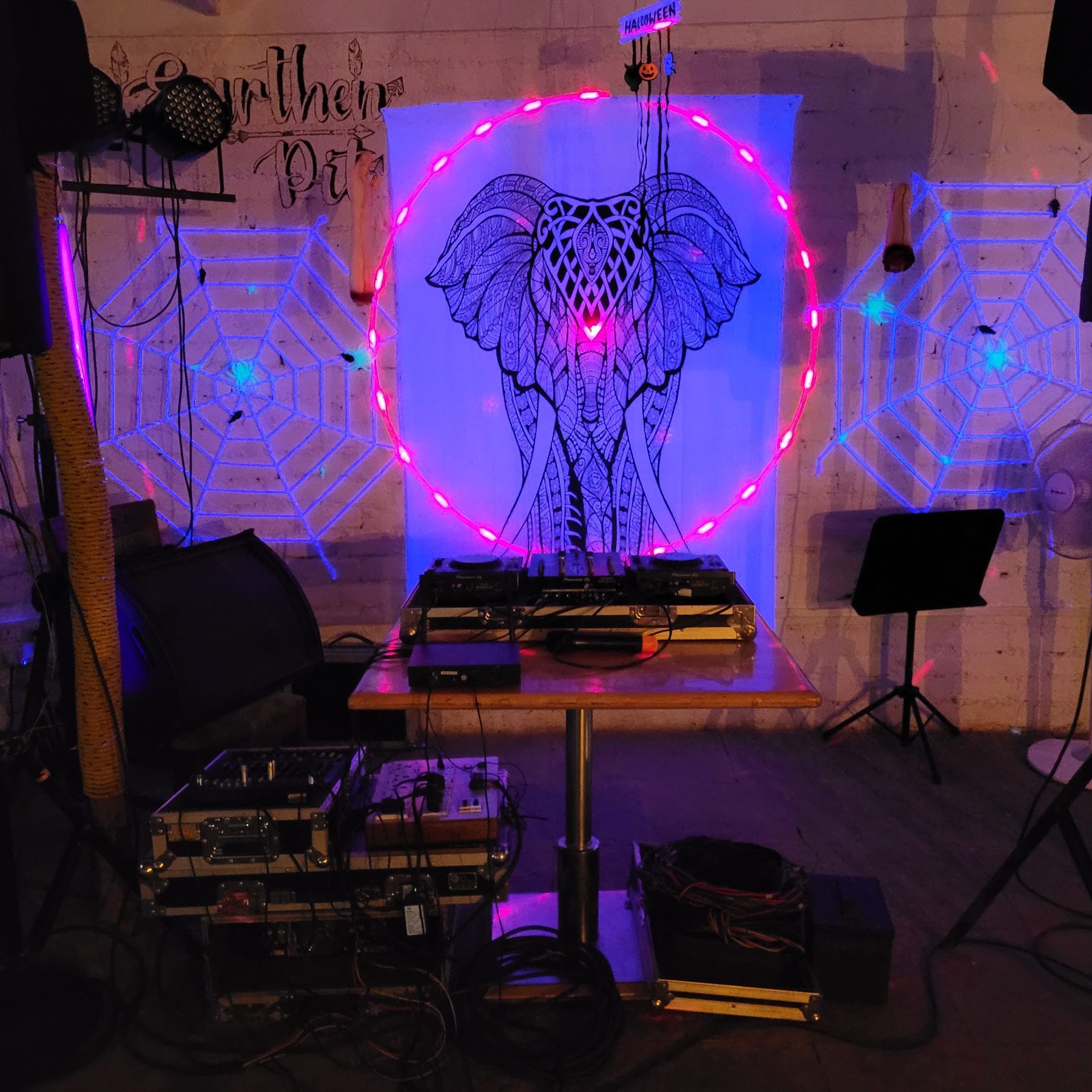 the café stage set up for a Friday night, decks and speakers under the mandala