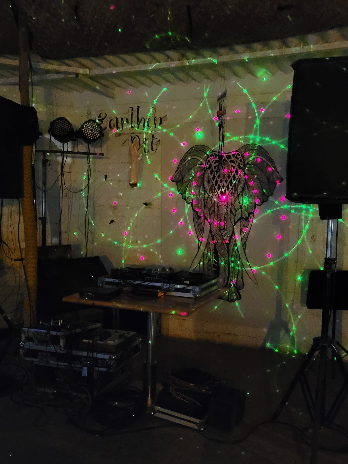 the café stage, speakers and decks lit green