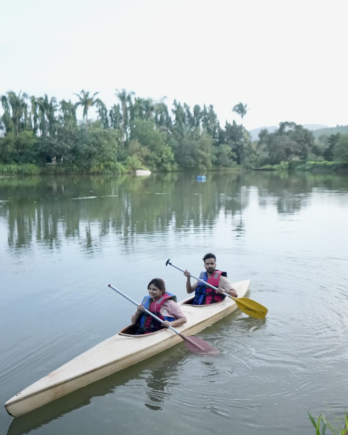 two guests kayaking on the still lake