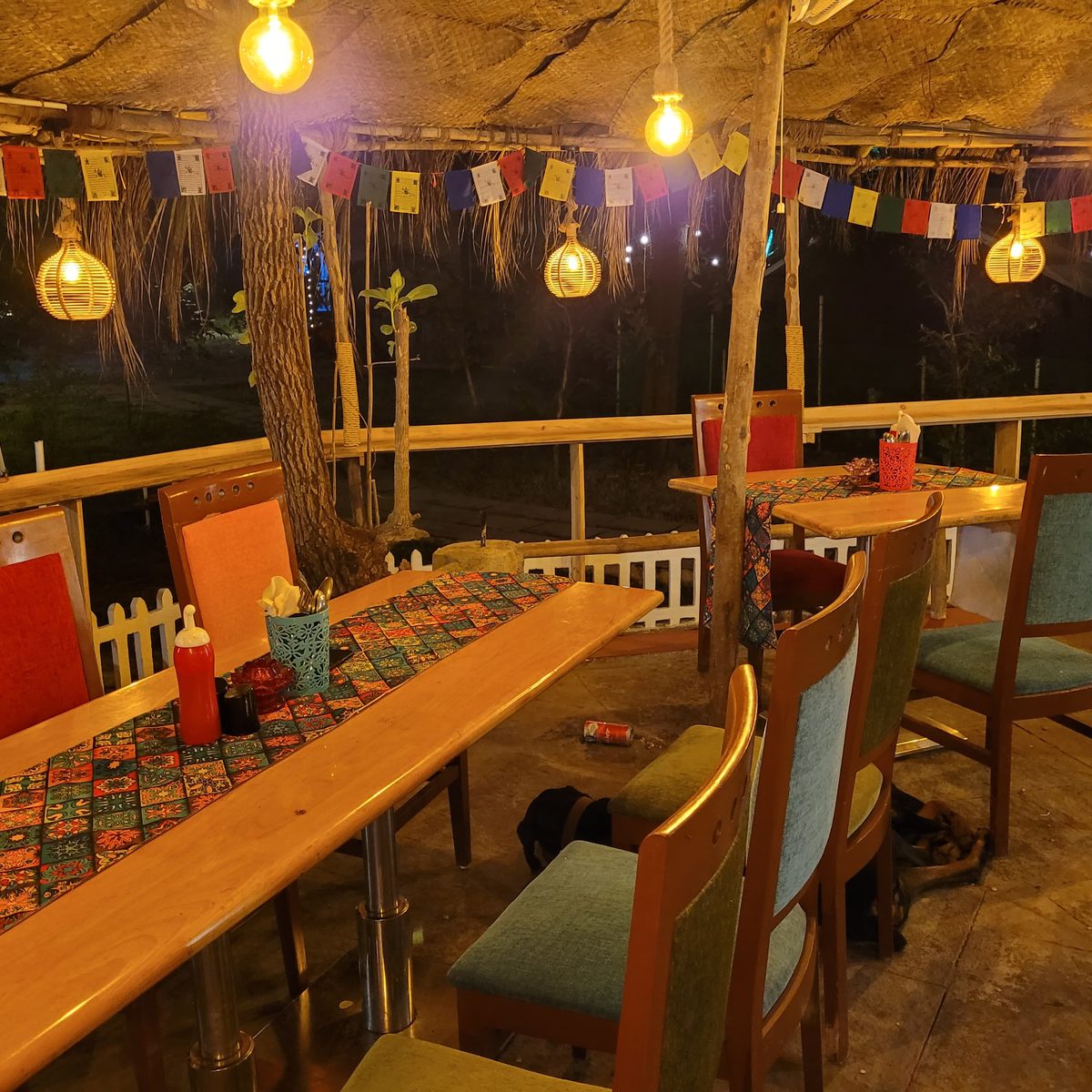 a café table laid under warm bulb light