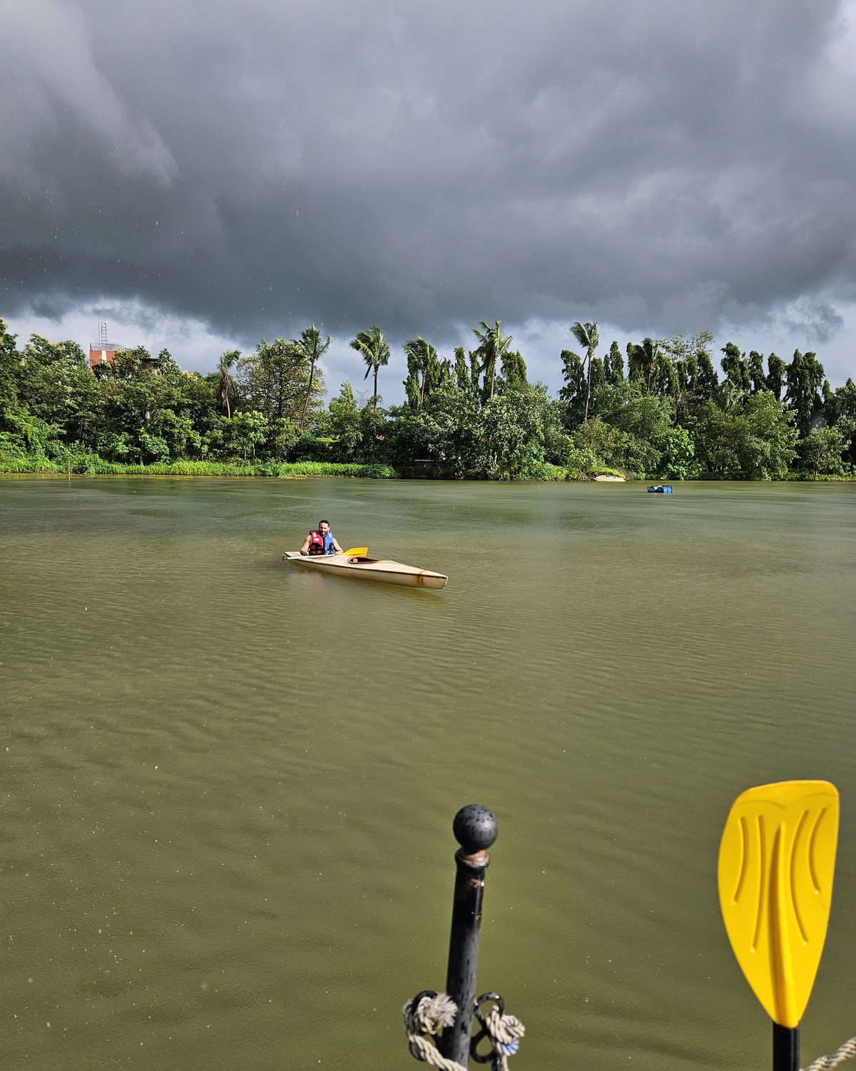 the lake under monsoon cloud, a kayak crossing