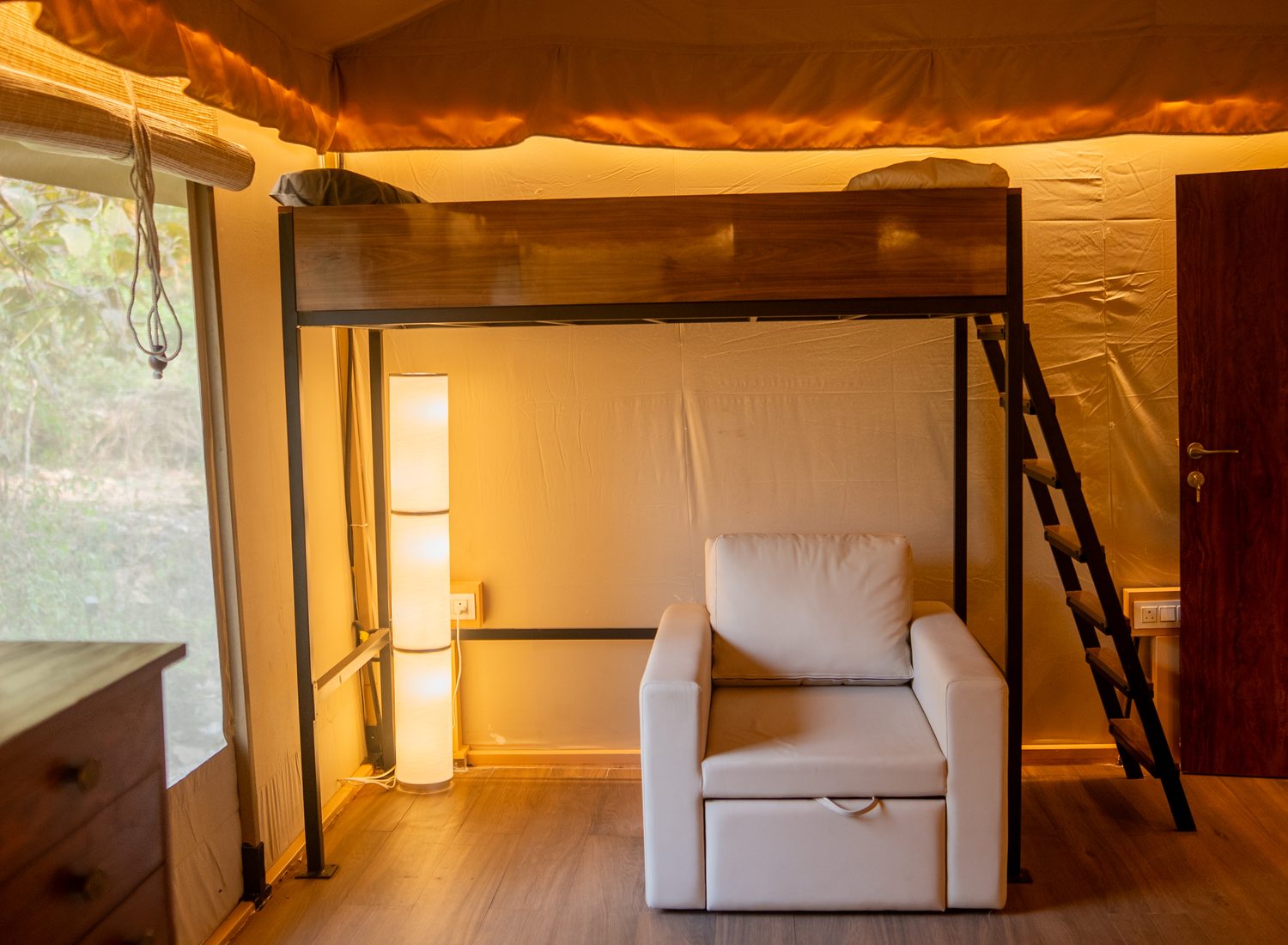 the loft and its ladder above the reading chair