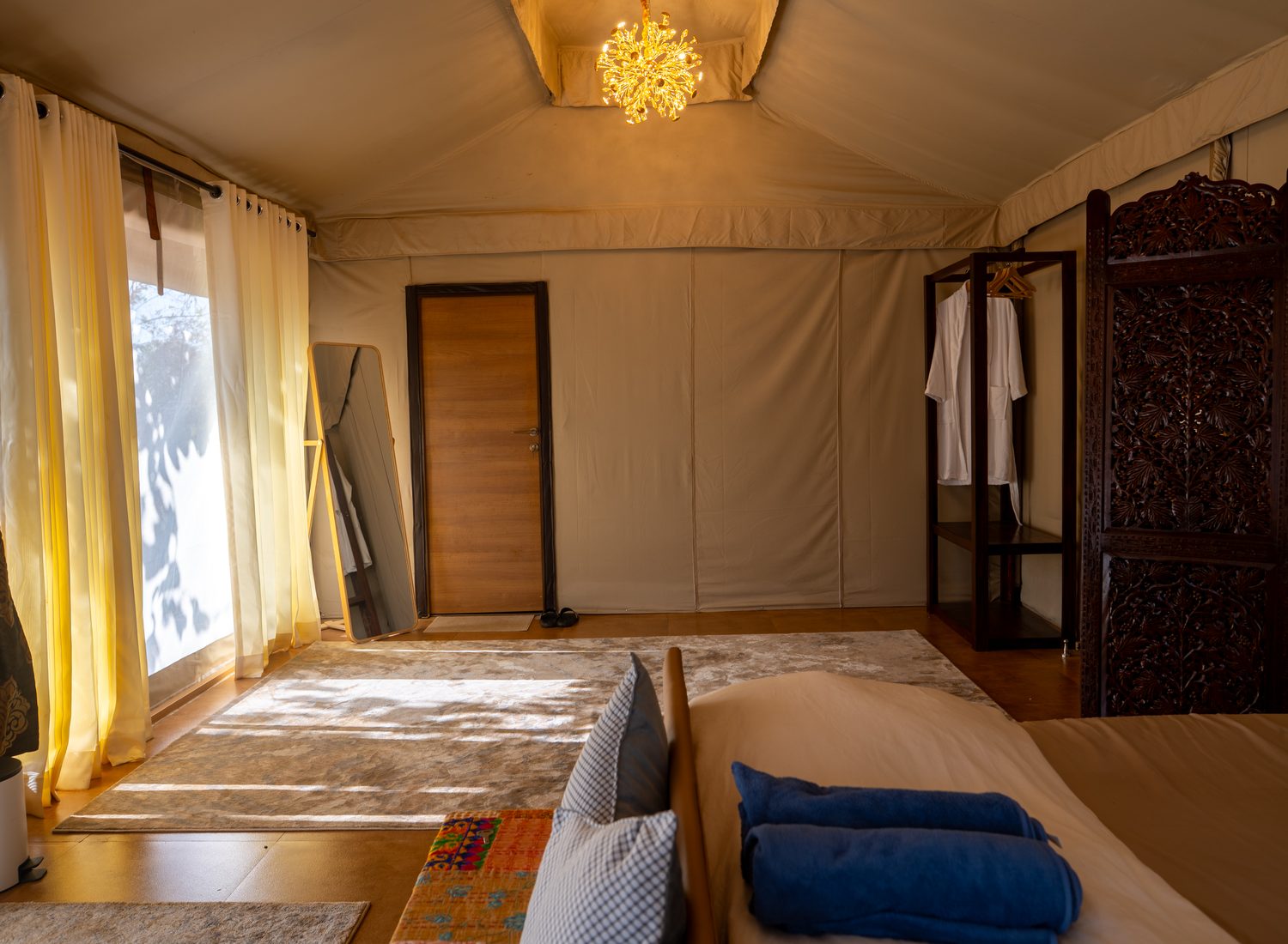 the length of the suite, curtains drawn back to the trees