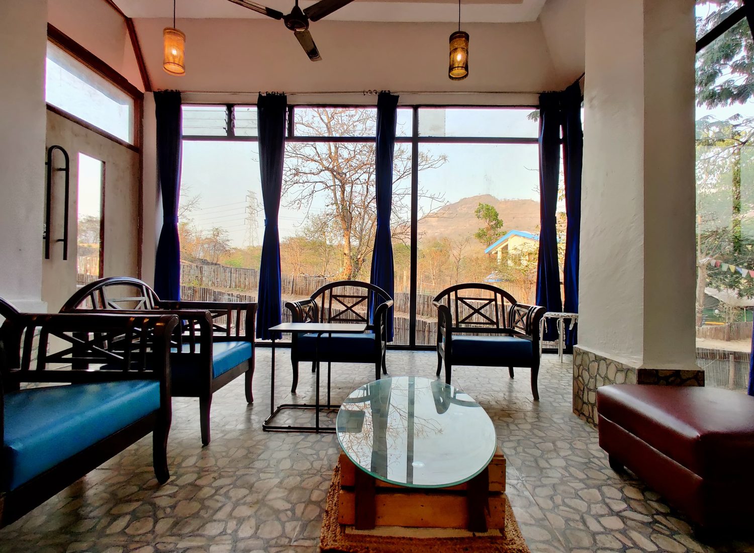 the villa living room, glass on three sides and hills beyond